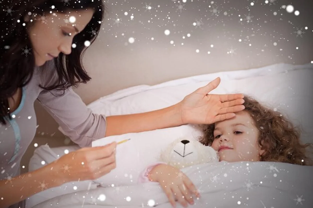 Matka mierzy temperaturę córkom